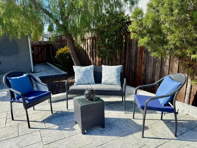 a outdoor space with patio the couches and a potted plant on a table and chairs
