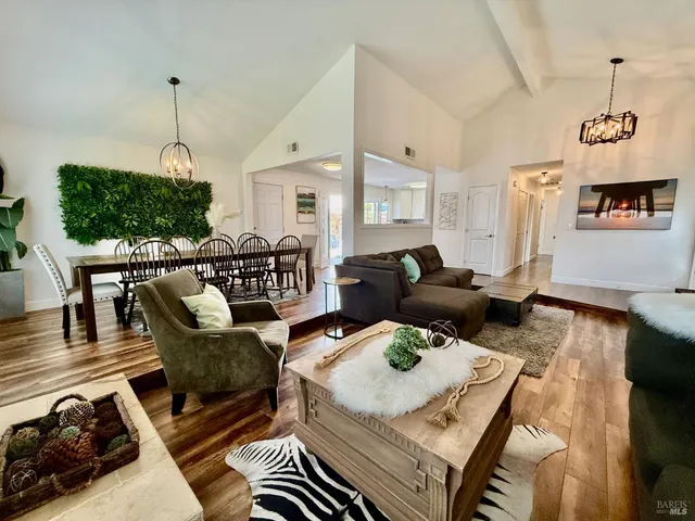 a living room with furniture and a chandelier