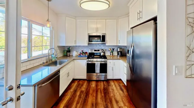 a kitchen with a refrigerator and a sink