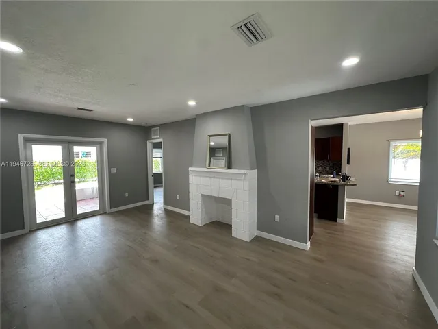 a view of a living room a stove and wooden floor