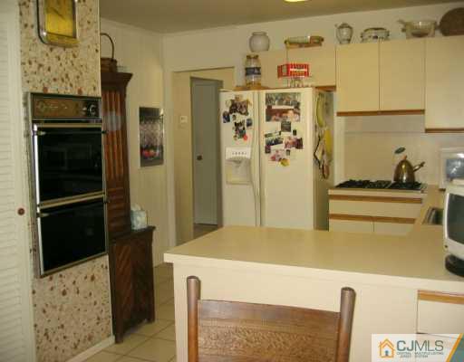 8 Grier Road Somerset, NJ 08873 - Photo 5 of 7 a kitchen with a refrigerator and cabinets