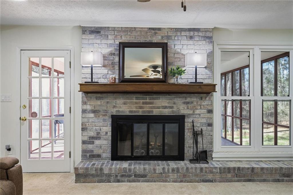 4505 Cochran Mill Road Fairburn, GA 30213 - Photo 10 of 36 a living room with a fireplace and a wooden floor