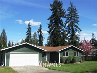 20029 Bartlett Road Bothell, WA 98012 - Photo 1 of 1 a front view of a house with a yard and garage