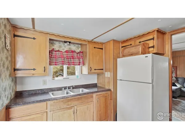 a kitchen with a refrigerator and a sink