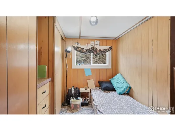 a living room with a bed and a painting on the wall