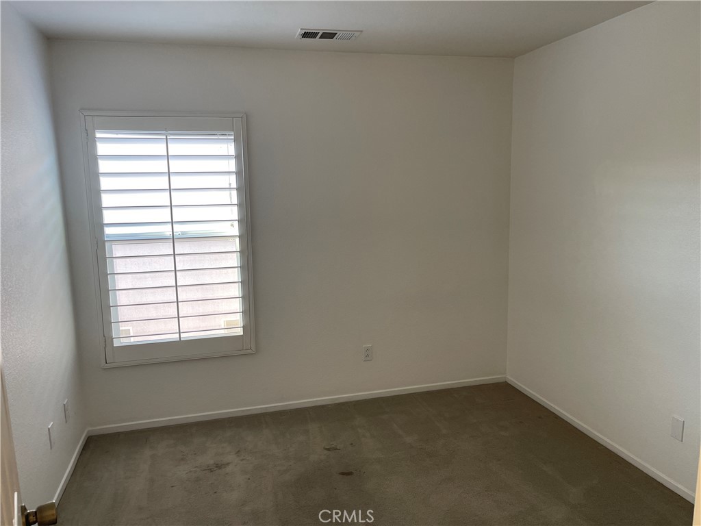 25248 Meadow Walk Street, Unit 1 Murrieta, CA 92562 - Photo 12 of 18 an empty room with a window