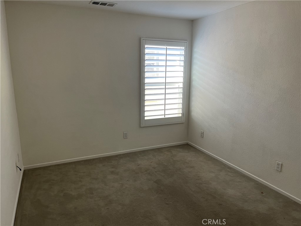 25248 Meadow Walk Street, Unit 1 Murrieta, CA 92562 - Photo 13 of 18 an empty room with a window