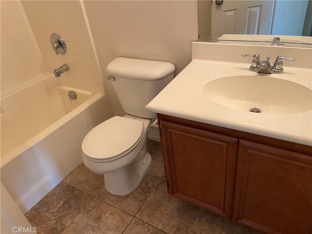 25248 Meadow Walk Street, Unit 1 Murrieta, CA 92562 - Photo 14 of 18 a white toilet sitting next to a bathroom sink