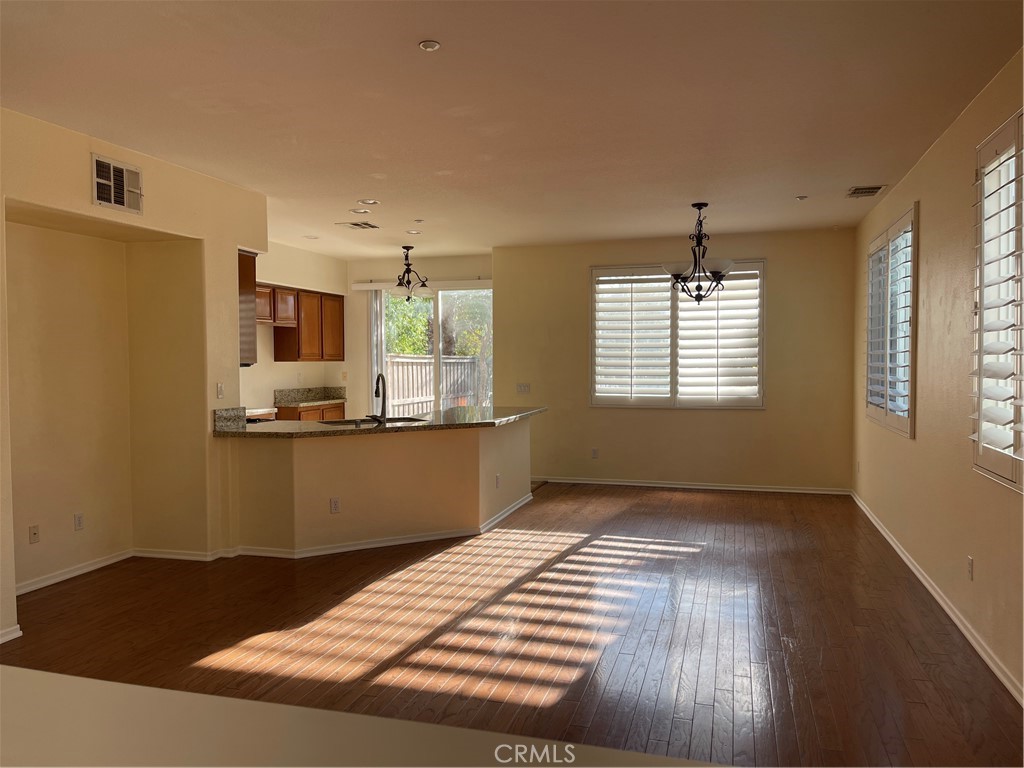 25248 Meadow Walk Street, Unit 1 Murrieta, CA 92562 - Photo 2 of 18 a view of kitchen and hall with wooden floor