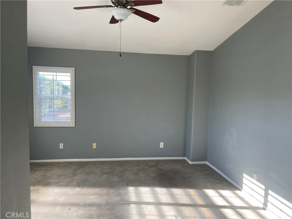 25248 Meadow Walk Street, Unit 1 Murrieta, CA 92562 - Photo 9 of 18 a view of a room with a ceiling fan and window
