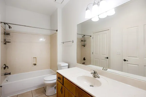 a bathroom with a sink toilet tub and shower