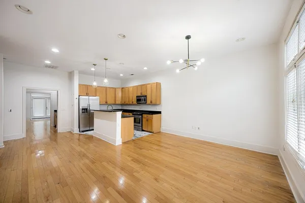 a kitchen with granite countertop a sink a stove and cabinets