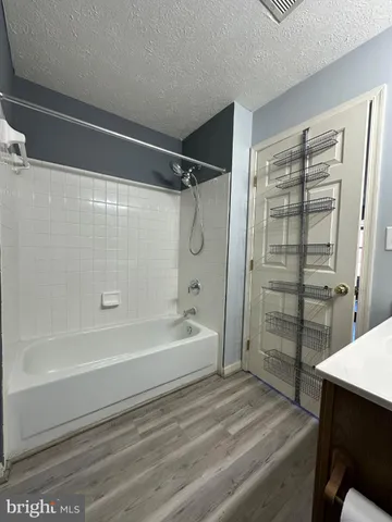 a spacious bathroom with a bathtub and a shower
