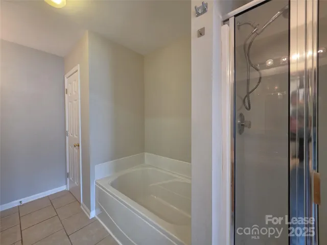 a bathroom with a tub and shower