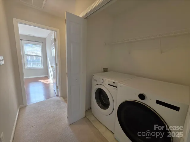 a view of storage and utility room with washer and dryer