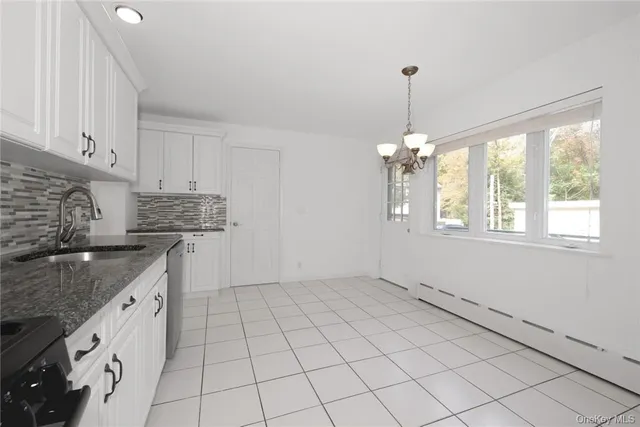a kitchen with a sink window and cabinets