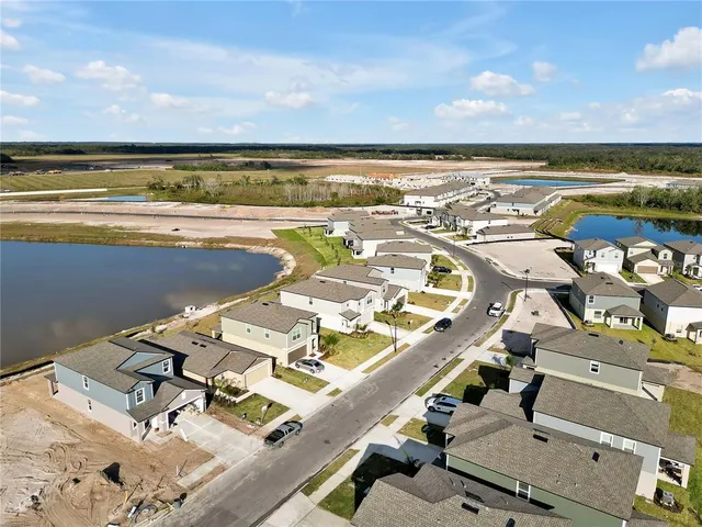 an aerial view of residential building with outdoor space and ocean view