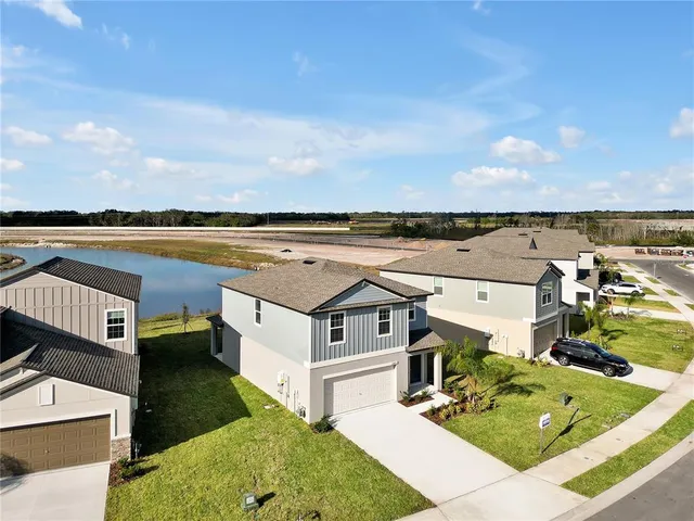an aerial view of a house with a lake view