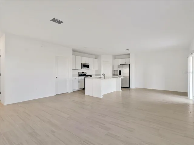 a view of kitchen with white cabinets and white appliances