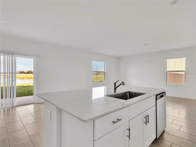 a kitchen with a sink and chandelier