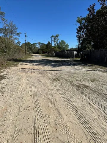 a view of a yard with a tree