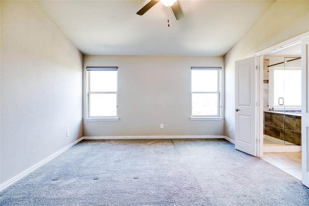 2317 Connor Way Carrollton, TX 75010 - Photo 21 of 37 an empty room with chandelier fan and windows