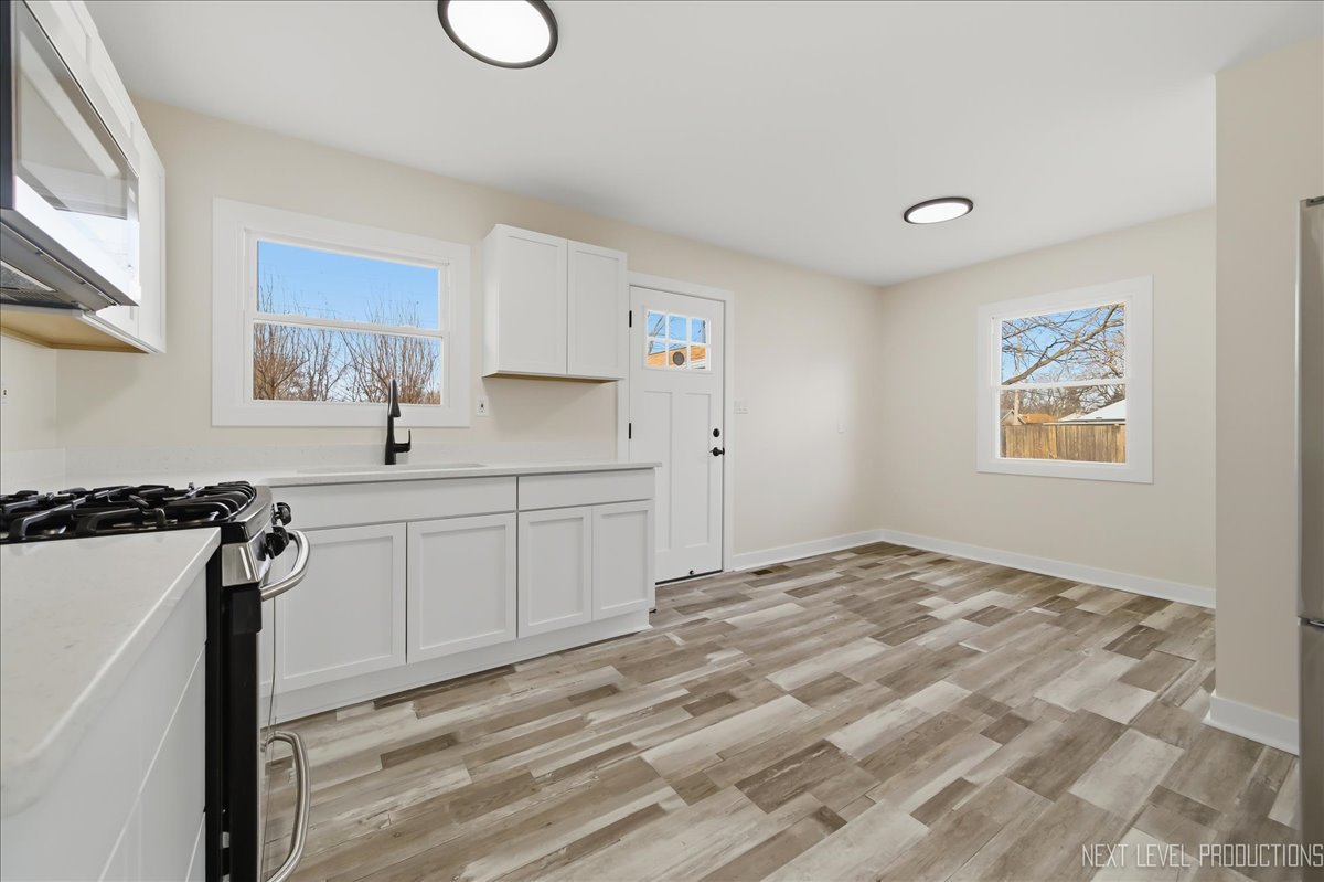 1401 Seminole Drive Ottawa, IL 61350 - Photo 5 of 24 a kitchen with a sink cabinets and a window