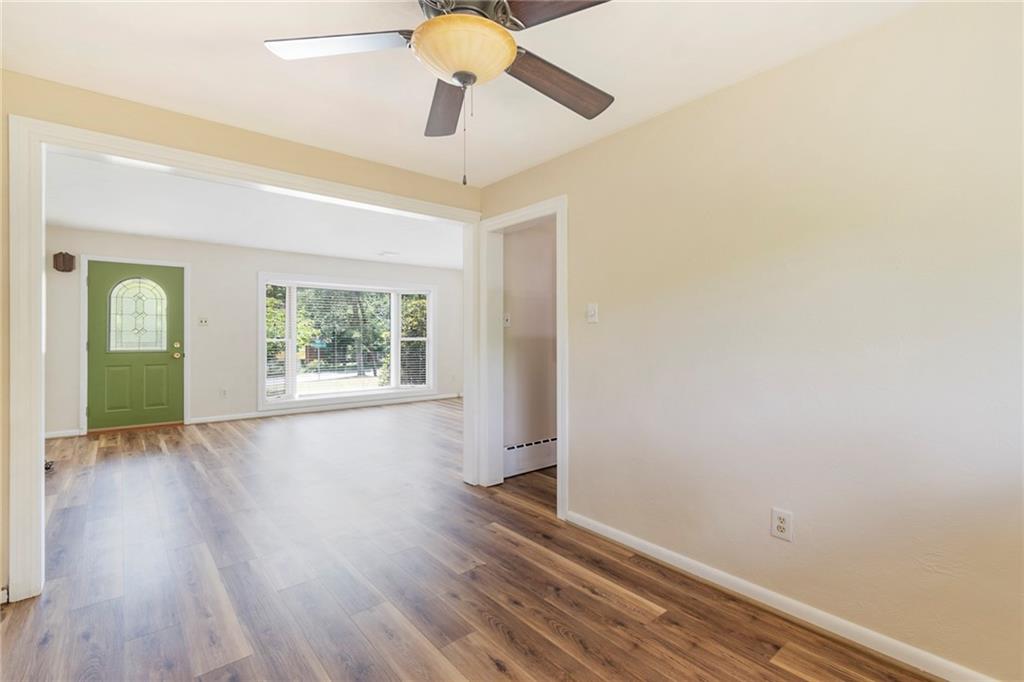 8855 Peebles Road Allison Park, PA 15101 - Photo 4 of 26 an empty room with wooden floor chandelier fan and windows