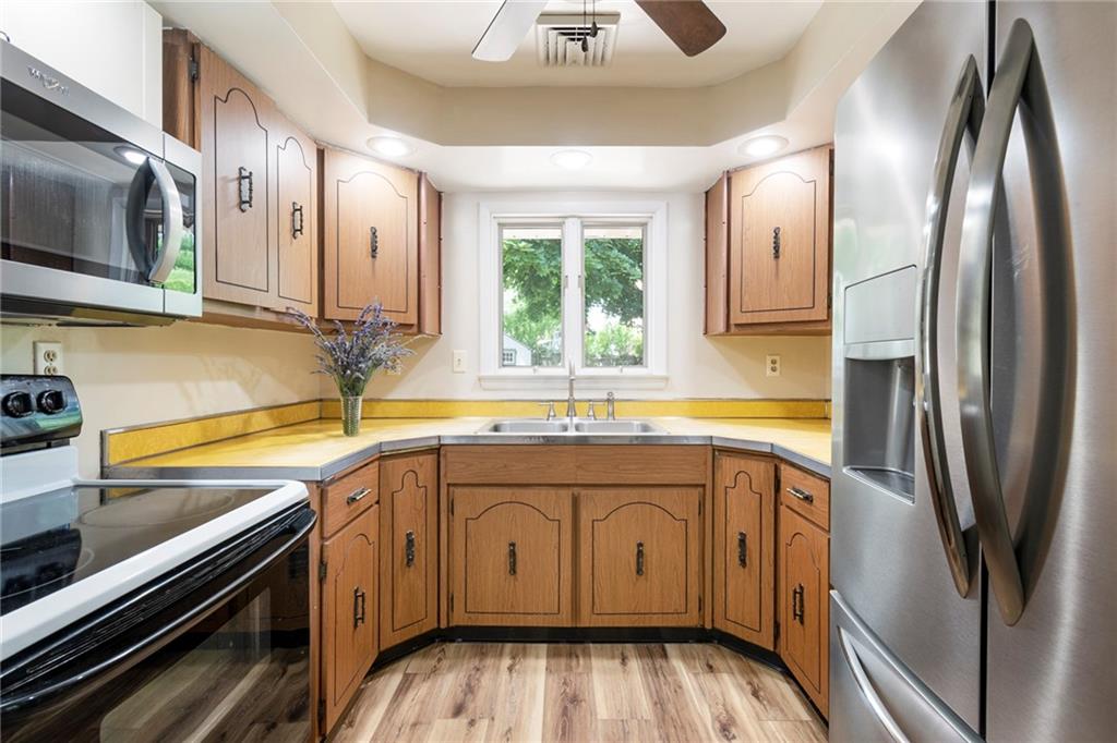 8855 Peebles Road Allison Park, PA 15101 - Photo 7 of 26 a kitchen with stainless steel appliances granite countertop a sink stove and refrigerator