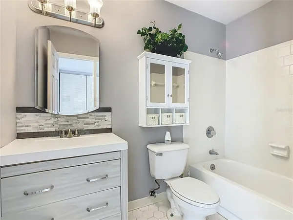 a bathroom with a toilet a sink and a bathtub