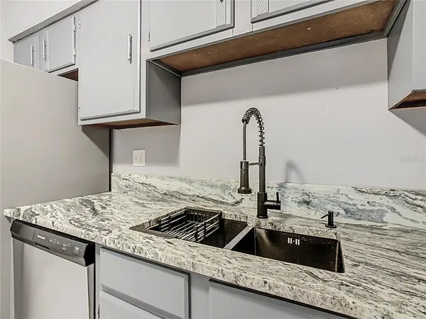 a kitchen with a sink and cabinets