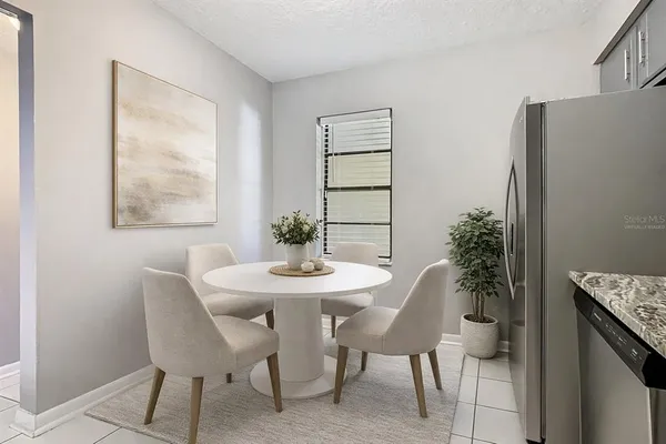 a view of a dining room with furniture and window