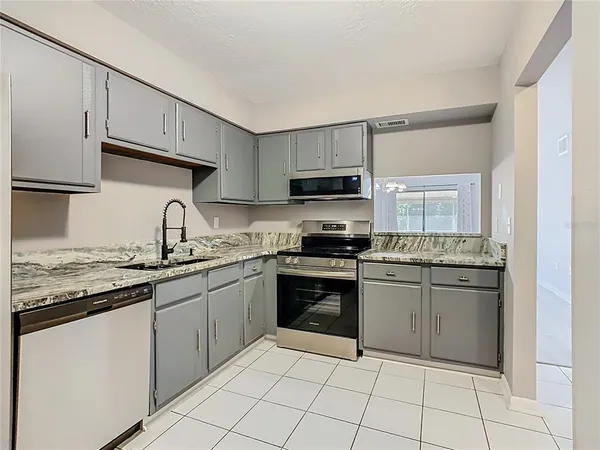 a kitchen with stainless steel appliances granite countertop a sink and stove top oven