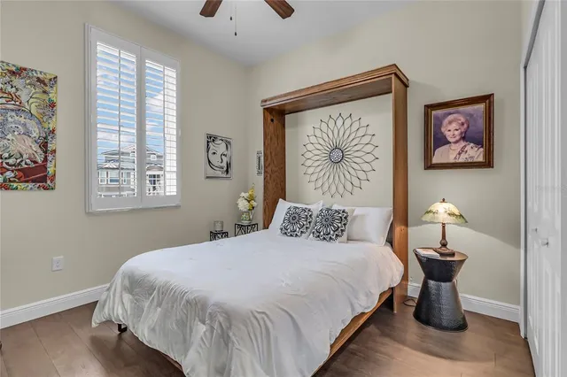 a bedroom with a bed and a painting on the wall