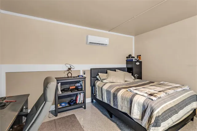 a bedroom with a bed and a desk