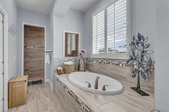 a bath tub sitting in a bathroom next to a window