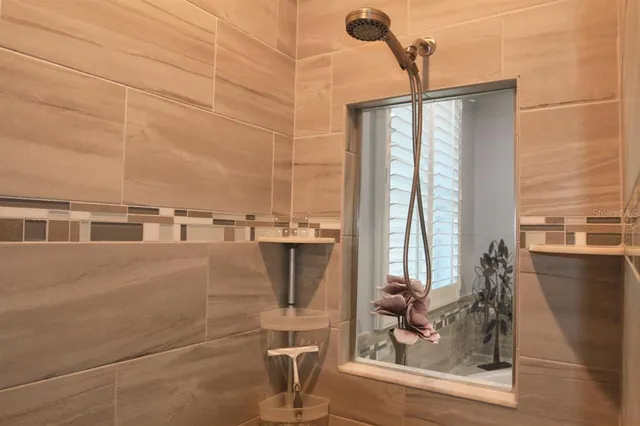 a bathroom with a bathtub and next to a window