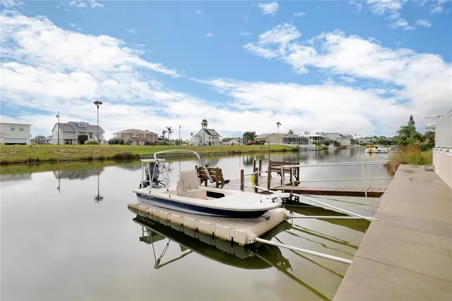 a view of a lake with couches chairs