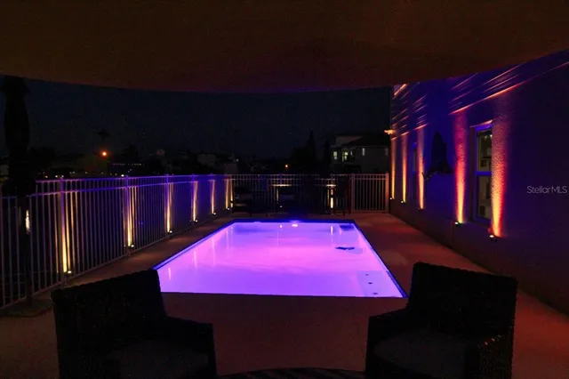 a view of a red car is parked in front of a building