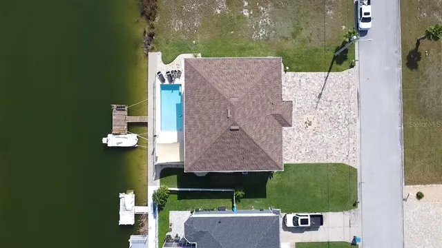an aerial view of a house with a yard