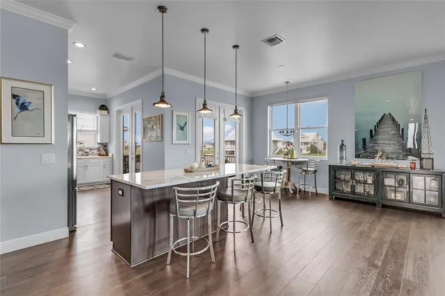 a view of kitchen with dining room and wooden floor