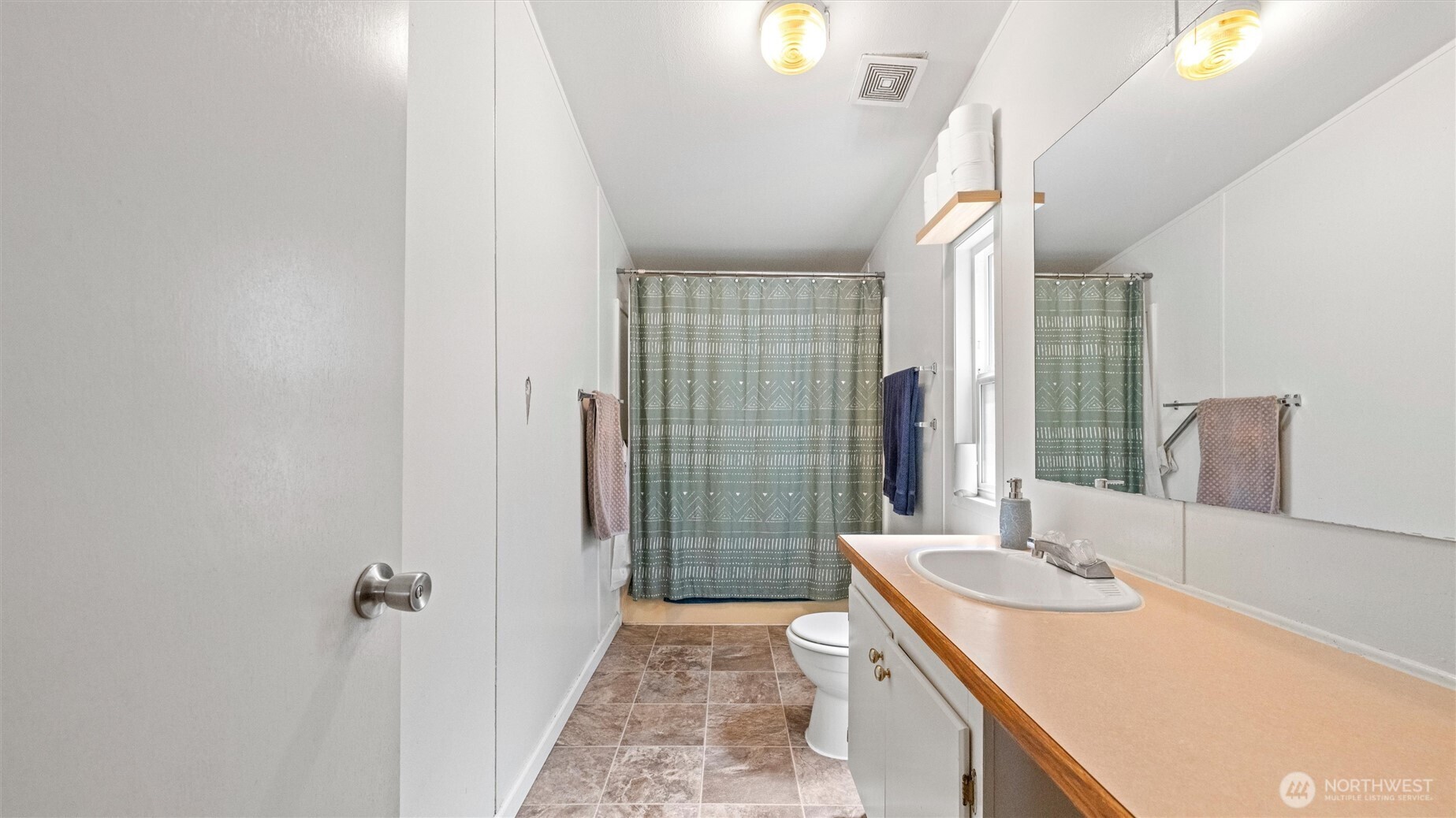 457 McKinney Road Walla Walla, WA 99362 - Photo 18 of 29 a bathroom with a granite countertop sink a mirror and shower