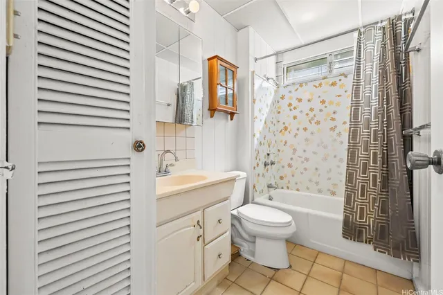 a bathroom with a sink a toilet and shower curtain