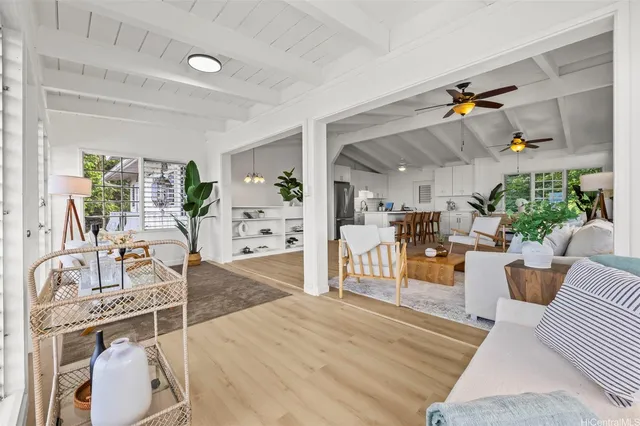 a living room with furniture and a wooden floor