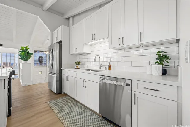 a kitchen with white cabinets and white appliances