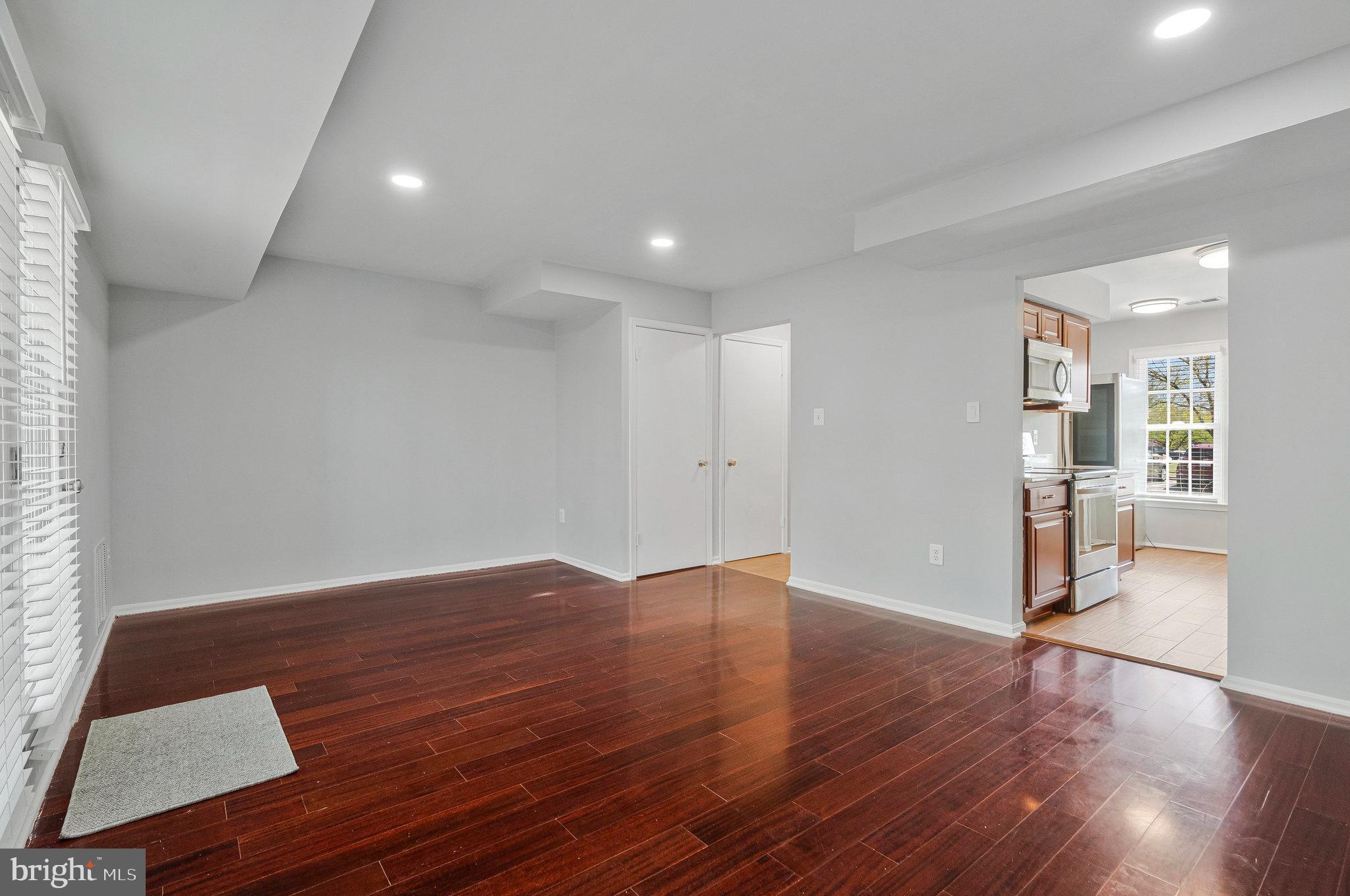 22303 Mayfield Square Sterling, VA 20164 - Photo 11 of 24 a view of wooden floor and windows in an empty room