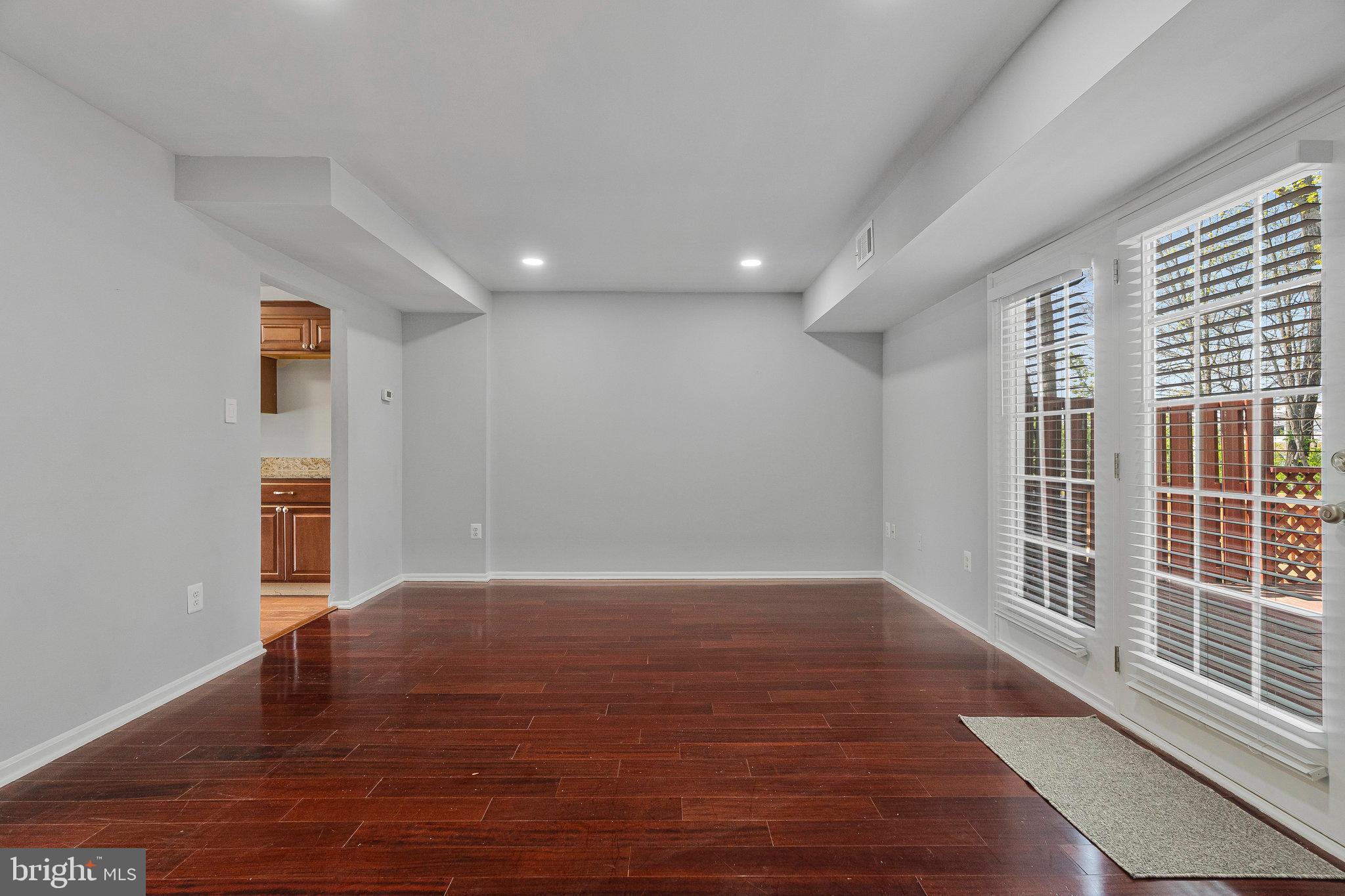 22303 Mayfield Square Sterling, VA 20164 - Photo 12 of 24 a view of an empty room with wooden floor and a window