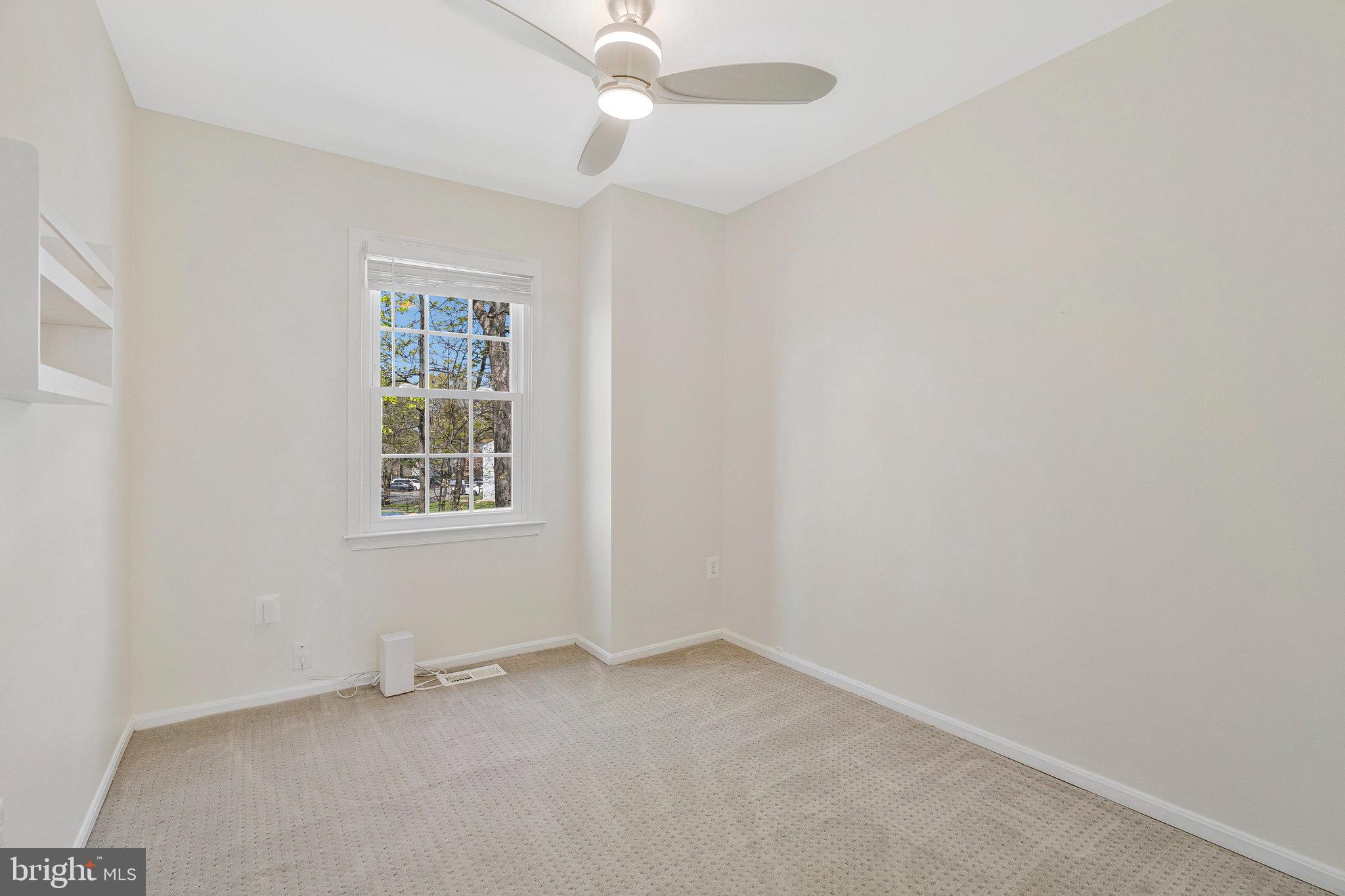 22303 Mayfield Square Sterling, VA 20164 - Photo 20 of 24 an empty room with a window and ceiling fan