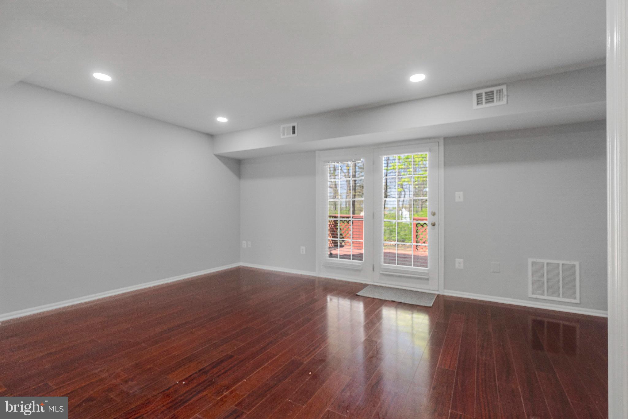 22303 Mayfield Square Sterling, VA 20164 - Photo 2 of 24 a view of empty room with wooden floor and fan
