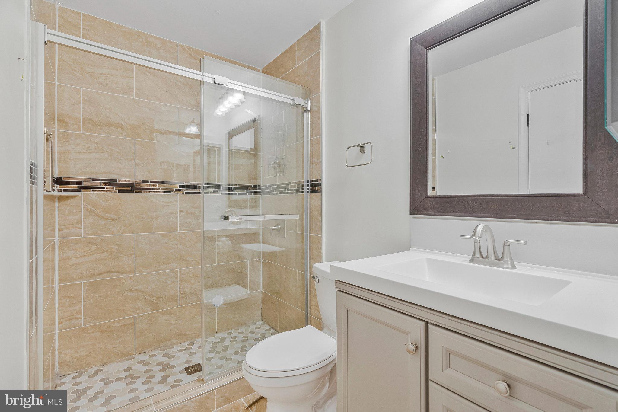 22303 Mayfield Square Sterling, VA 20164 - Photo 4 of 24 a bathroom with a sink a toilet and shower